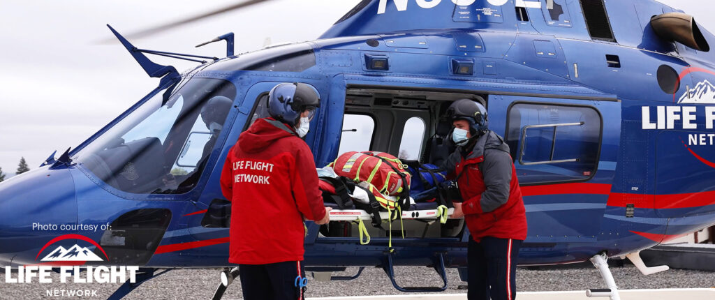 Life Flight Network team loading a patient into a helicopter, featuring reliable connectivity solutions from Bigleaf Networks to enhance remote medical rescue missions