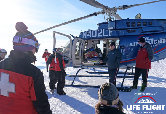 Emergency response team at a snowy location with a Life Flight helicopter, equipped with Bigleaf Networks connectivity for seamless communication during critical rescue operations